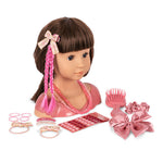 The Konges Slojd Stella Styling Doll, featuring playful pink-braided brown hair, comes with a brush, hair ties, scrunchies, and beads for endless styling fun.