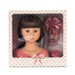 The Konges Slojd Stella Styling Doll with brunette hair comes in a charming polka dot box, ideal for creative hair styling. It includes pink hair accessories: a bow, clips, and a comb to spark imagination.