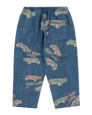 The Konges Slojd Baby Boys' and Boys' Magot Pants feature a blue denim straight fit, elastic waist, back pocket, and an all-over vintage race car print with the words "EAST LANE.