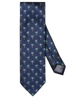 The Eton Navy Palm Tree Tie, expertly crafted in Italy, showcases a dark blue silk with a repeating pattern of small, light green palm trees.