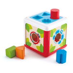 The Hape Shape Sorting Box is a wooden educational toy for toddlers, featuring a cube and four colorful shapes—green square, orange triangle, blue flower, and red cylinder—to encourage early learning through hands-on play.
