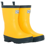 A pair of Hatley Yellow & Navy Matte Rain Boots for kids, featuring slip-resistant rubber soles and navy trim, are placed side by side on a white background.