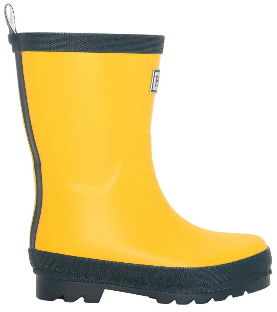 A single Hatley Yellow & Navy Matte Rain Boot is shown from the side on a white background, featuring a yellow design with navy trim and slip-resistant rubber tread.