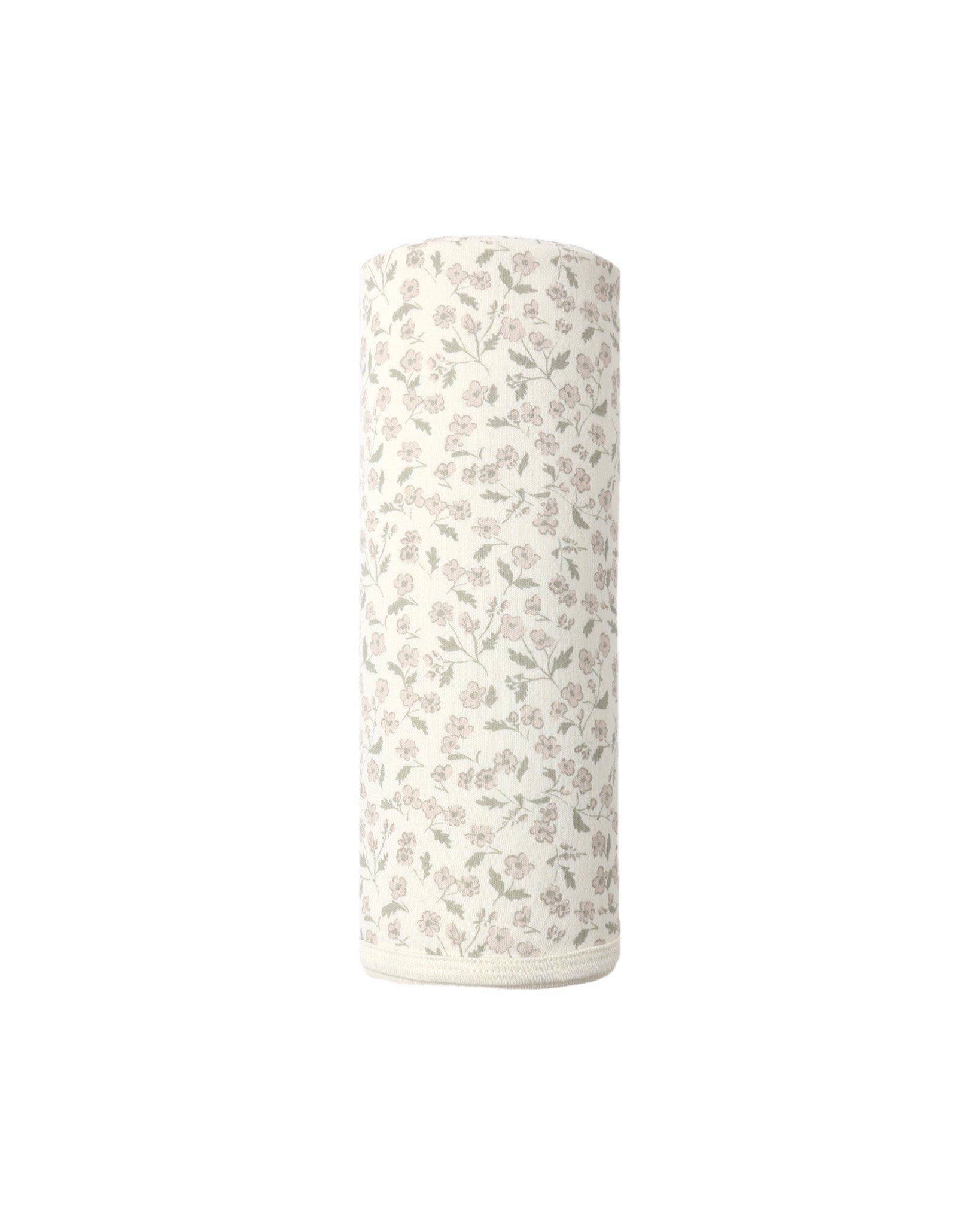 A white cylindrical roll of Quincy Mae’s Swaddle, featuring a subtle floral pattern in light gray and pink on organic brushed jersey, shown upright against a plain white background—ideal for gently wrapping your baby.