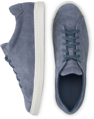The Peter Millar Vantage Lite Suede Sneaker, shown in blue with a comfort-enhancing suede upper and white rubber soles, is featured from the side and top view against a white background.