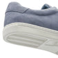 Close-up of the heel and sole of the Peter Millar Vantage Lite Suede Sneaker in light blue, showcasing its suede upper and white rubber outsole. The image highlights the tread pattern and part of the upper, emphasizing a comfort-focused design.