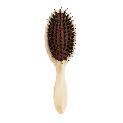 The Machete Petite Travel Hair Brush, featuring dark detangling bristles and a curved wooden handle, is displayed against a white background.