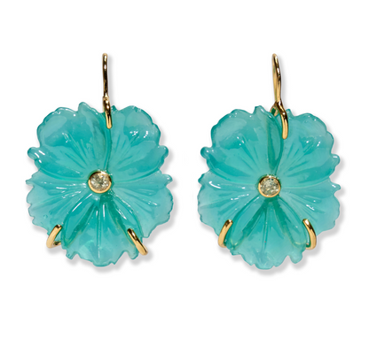 The New Bloom Earrings by Lizzie Fortunato feature turquoise mother-of-pearl flower drops with gold hooks and a central sky blue topaz gemstone on each bloom.