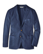 The Peter Millar Weekend Soft Jacket is a navy blue garment-dyed blazer with two brown buttons, front patch pockets, a breast pocket, and notch lapels, shown against a white background.