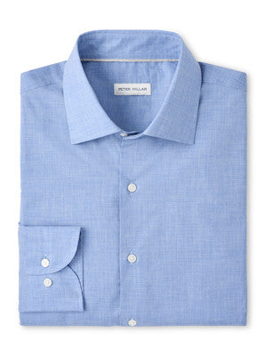 The Brighton Perfect Poplin Sport Shirt by Peter Millar is a neatly folded light blue shirt featuring a spread collar, front pocket, white buttons, and a visible brand label inside the collar.