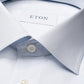 Close-up of the Eton Contemporary Striped Twill Shirt in light blue, featuring subtle stripes, a pointed collar, white buttons, and the signature Eton label inside the collar. Made from 100% cotton, this shirt combines comfort and refined elegance for any occasion.