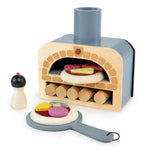 The Tender Leaf Toys "Tenderleaf Make Me a Pizza!" wooden toy pizza oven set is perfect for pretend play, featuring various food ingredients like a pepper shaker, pretend logs, and pizza slices on a paddle with assorted pizza toppings.