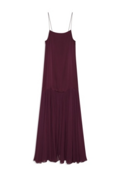 The Clementine Dress by Anine Bing is a sleeveless, dark purple satin dress with a modern silhouette, thin spaghetti straps, and a flowy, pleated skirt, shown against a white background.