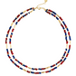 Anabel Aram Milos Beaded Necklace featuring two strands of red, turquoise, and lapis lazuli beads accented with elongated gold-tone metal beads.