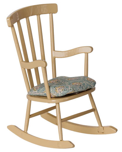 The Maileg Rocking Chair, Mouse - Wheat is a comfortable farmhouse-style wooden rocking chair featuring vertical slats on the backrest, a light yellow finish, and a blue patterned seat cushion.