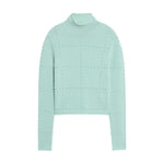 The Popcorn Cashmere Top by Guest in Residence is a light blue women’s mock neck sweater with long sleeves and a chic grid pattern of raised, round textured dots for a stylish popcorn design.