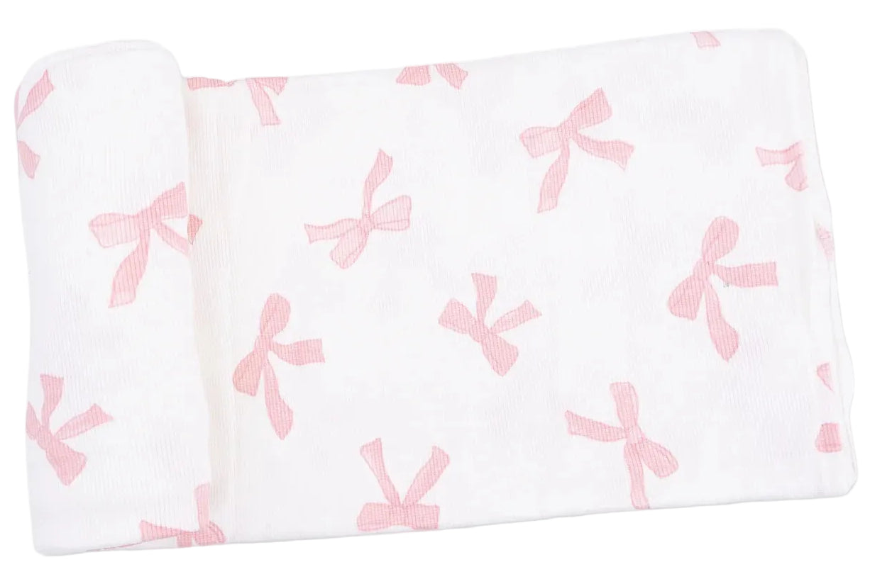 Crafted from ultra-soft Viscose from Bamboo Swaddle fabric, the Angel Dear Swaddle Blanket features a charming white background adorned with an evenly spaced pattern of pink bows, making it perfect for wrapping your little one in comfort.