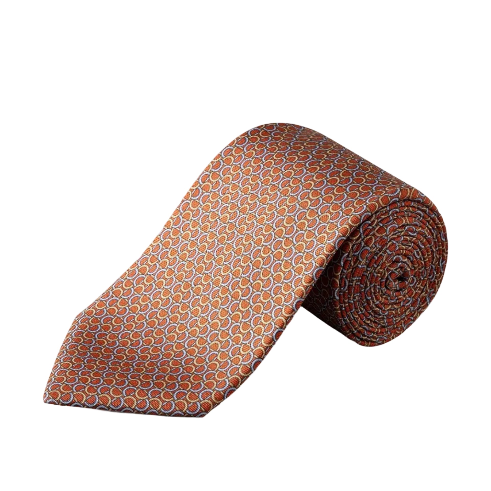 Eton’s Geometric Printed Silk Tie, featuring an orange base with a repeating geometric pattern in blue and white, is rolled up on a white background—a perfect accessory for introducing business sophistication to any ensemble.
