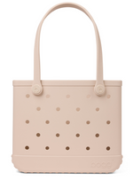 The Baby Bogg® Bag by Bogg Bags is a light beige, rectangular, customizable tote with circular holes, two handles, and “bogg” embossed on the lower right front. This washable and durable bag is ideal for everyday use and simple to keep clean.