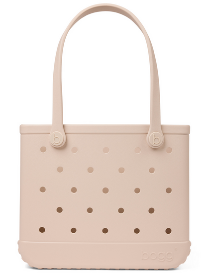 The Baby Bogg® Bag by Bogg Bags is a light beige, rectangular, customizable tote with circular holes, two handles, and “bogg” embossed on the lower right front. This washable and durable bag is ideal for everyday use and simple to keep clean.