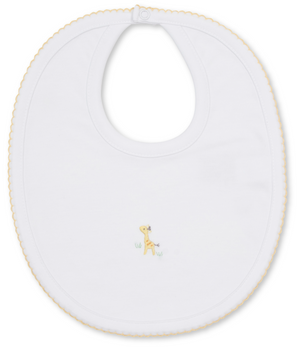 The Kissy Kissy Premier Giraffe Love Hand Emb. Bib is crafted from soft Peruvian cotton in white, accented with yellow trim and adorned in the center with a delicate hand-embroidered giraffe standing on grass.