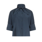 The Tie One On Shirt by TWP is a dark blue vintage washed poplin blouse, designed with a high neck and tied bow, elbow-length sleeves, and a relaxed fit.