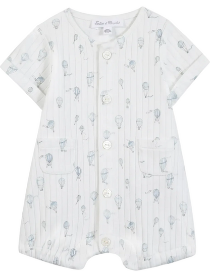 The Tartine et Chocolat Baby Boys’ Hot Air Balloon Short Jumpsuit features soft white cotton, short sleeves, front buttons, two pockets, and a subtle blue hot air balloon print—an ideal everyday newborn outfit that offers both comfort and style.