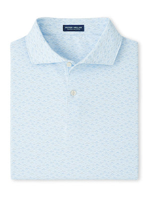 The Peter Millar Soprano Waves Performance Jersey Polo is a light blue short-sleeve shirt featuring a subtle pattern, four-way stretch, and UPF 50+ sun protection, neatly folded with the collar and two buttons visible.