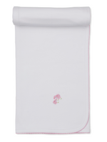 The Kissy Kissy Premier Sweet Sheep Blanket is a white Pima cotton baby blanket featuring pink stitched edges, rolled at the top, and a small embroidered pink bear holding a flower in the center.