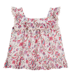 The Louise Misha Girls’ Inessa Blouse is a sleeveless cotton top for girls, showcasing a pink, red, and blue floral pattern. It features a square neckline with delicate lace details along the neckline and shoulders, as well as ruffled lace trim on the shoulders and hem.