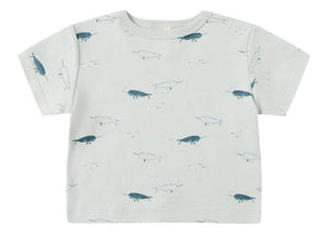 The Quincy Mae Baby and Kids' Boxy Tee is a comfy light grey toddler shirt featuring a cute all-over blue narwhal print.