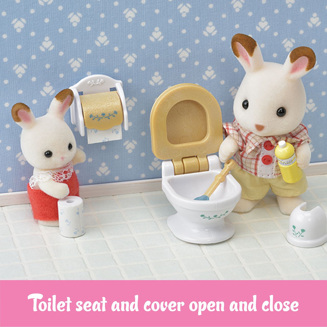Two Calico Critters figures from the Country Bathroom Set stand in a charming bathroom scene: one is cleaning a toilet with its lid open, while the other stands beside a toilet paper roll—an adorable addition to any dollhouse furniture or country-themed bathroom collection.