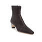 The Staud Wally Woven Leather Ankle Boot is a dark brown, pointed-toe leather ankle boot with a woven texture and blade mid-heel.