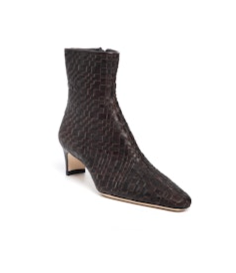 The Staud Wally Woven Leather Ankle Boot is a dark brown, pointed-toe leather ankle boot with a woven texture and blade mid-heel.