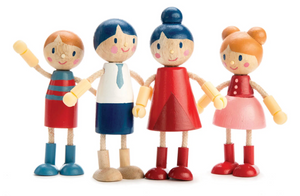 Four wooden dolls from the Tender Leaf Toys Doll Family, each with painted faces and vibrant outfits, stand closely together, smiling and holding hands. One figure on the left raises its arm in a playful gesture, making this cheerful set the perfect addition to any dolls house.
