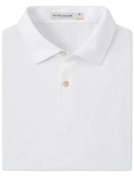 A folded Featherweight Mélange Polo in white, featuring a collar with two buttons and "Peter Millar" on the label. Made from lightweight performance fabric, it provides moisture-wicking and UPF 50+ for comfort on sunny days.