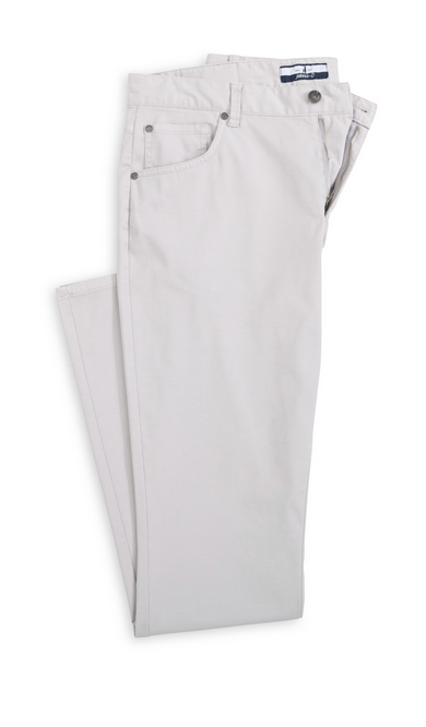 The Johnnie-O Atlas 5-Pocket Pant is a neatly folded pair of light gray pants made from garment-dyed stretch twill, featuring front pockets, belt loops, and a button closure.