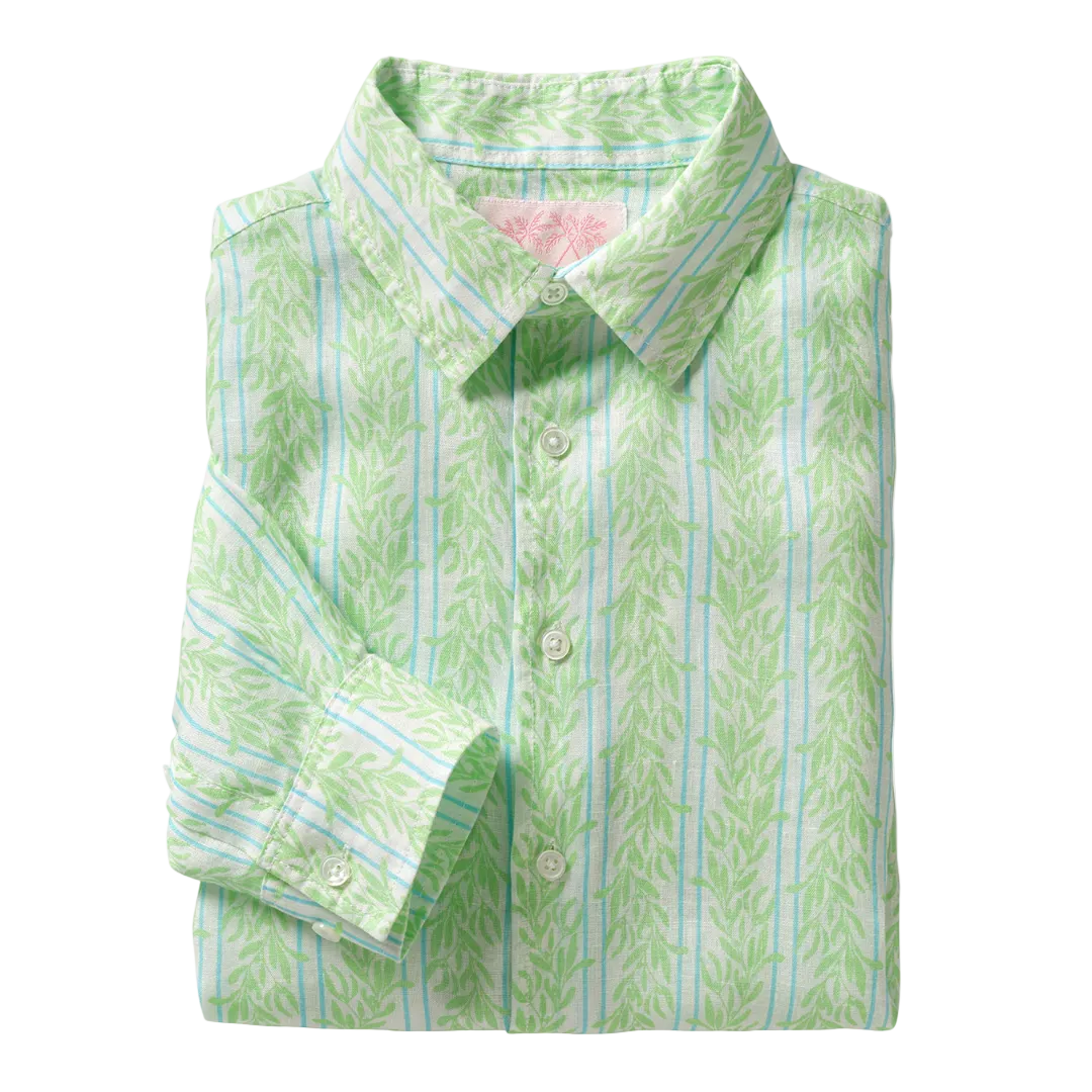 The Pink House Mustique Printed Linen Shirt is a long-sleeve, button-up linen shirt, folded neatly and featuring a light green and white leaf pattern inspired by the relaxed elegance of Mustique, finished with a pointed collar.