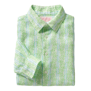 The Pink House Mustique Printed Linen Shirt is a long-sleeve, button-up linen shirt, folded neatly and featuring a light green and white leaf pattern inspired by the relaxed elegance of Mustique, finished with a pointed collar.