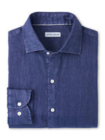 The Peter Millar Shoreside Linen Sport Shirt is a folded, long-sleeve solid navy shirt with a spread collar and white buttons, garment dyed for softness.