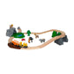 The Brio Safari Adventure Set features a wooden train, tracks, vehicles, animal figures, trees, rocks, and a pond in an oval layout—perfect for inspiring safari fun.