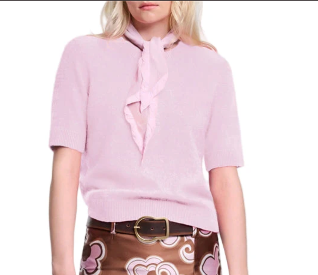A woman wearing the Fluffy Statements Pullover by Dorothee Schumacher in light pink with a matching scarf and a brown skirt accented by pink and white swirls.