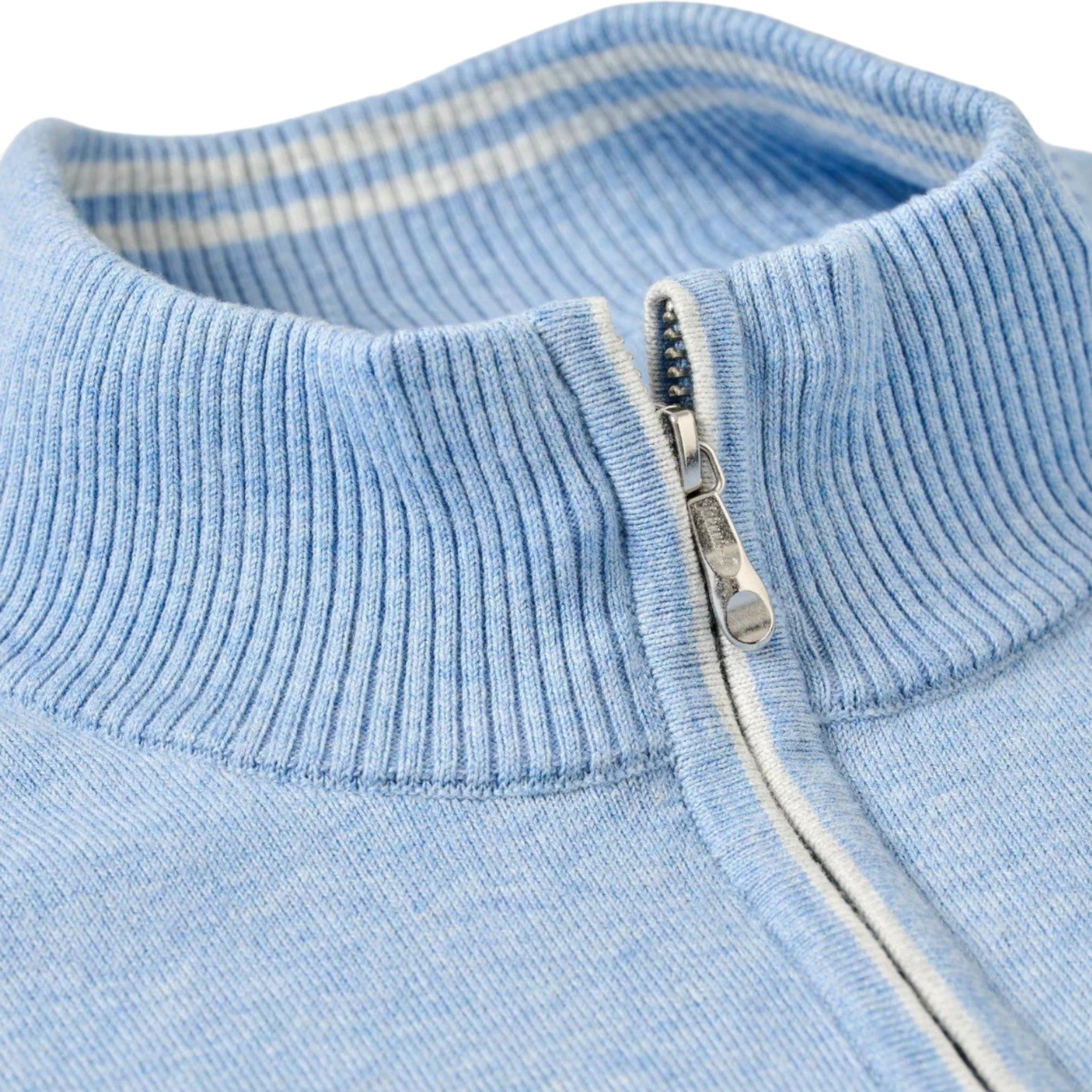 Close-up of the Desmond Quarter Zip by Johnnie-O, a light blue cotton-heavy sweater with a ribbed collar and inner white stripe, highlighting its refined plaited knit texture.