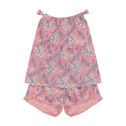 The Mer Girls’ Colette Top and Shorts Set, shown flat on a white background, features a pink floral print and sleeveless cotton top paired with fringe-trim shorts and frayed hems—capturing effortless French summer style.