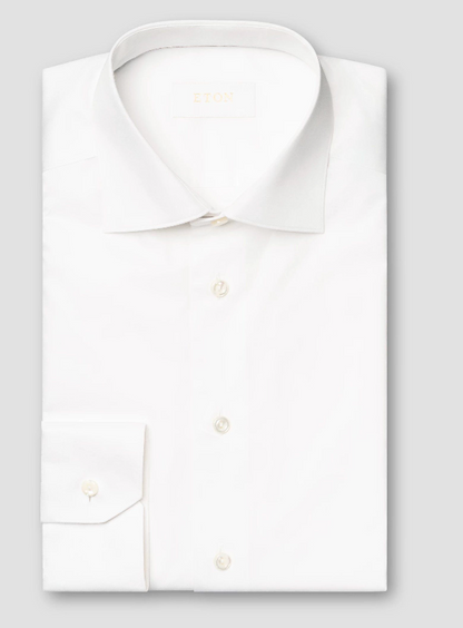The Eton Solid Elevated Twill Shirt, crafted from white Supima cotton with a spread collar and buttoned cuffs, is neatly folded and displayed against a plain light gray background.