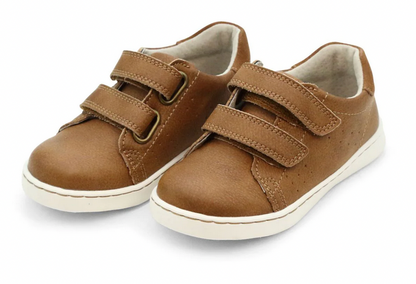 The Boys' Kyle Double Strap Sneaker by L'Amour Shoes is a brown children's shoe with white soles, two Velcro straps per shoe, and a supportive leather sockbed, shown against a white background.