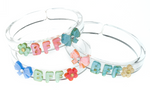 Add a fun and playful accent to your outfits with the Lillies & Roses Bows Best Friends Forever Pastel Bangles. These three clear plastic bracelets feature pastel-colored flowers, bows, and “BFF” letters in green, pink, and blue—making them the perfect accessory for celebrating friendship in style.