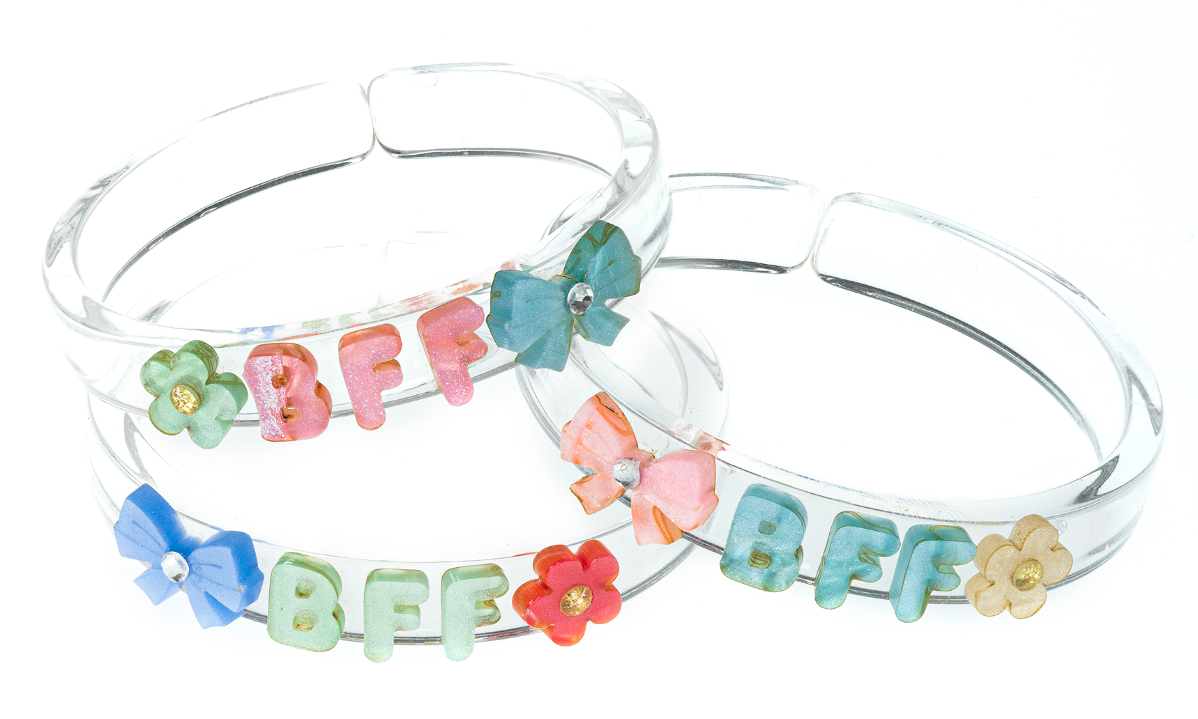 Add a fun and playful accent to your outfits with the Lillies & Roses Bows Best Friends Forever Pastel Bangles. These three clear plastic bracelets feature pastel-colored flowers, bows, and “BFF” letters in green, pink, and blue—making them the perfect accessory for celebrating friendship in style.