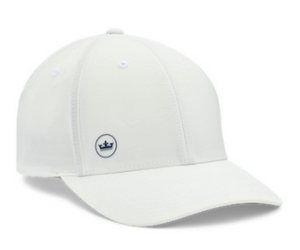 The Peter Millar Off Set Crown Seal Performance Hat is a white, lightweight hat with a small circular navy crown patch on the front and moisture-wicking fabric to keep you cool and comfortable all day.