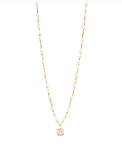 The Puce Diamond Necklace 16.5" by Gigi Clozeau features an 18-carat gold chain with white beads and a circular crystal pendant, adding timeless elegance to any outfit.